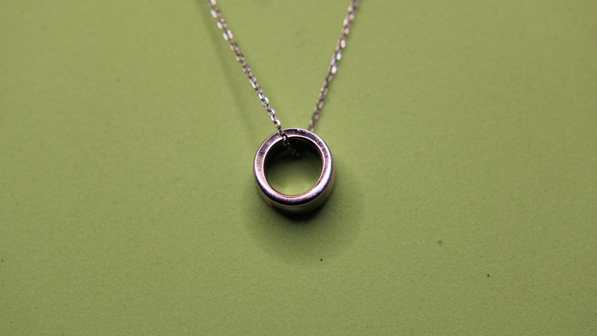 Silver necklace with a circular pendant