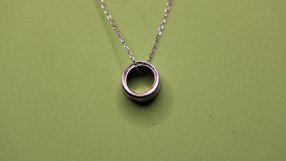 Silver necklace with a circular pendant